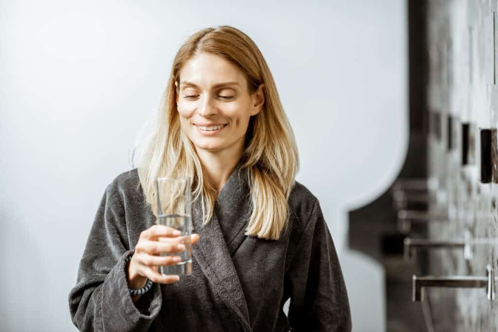 Woman drinking mineral water at the pump-room