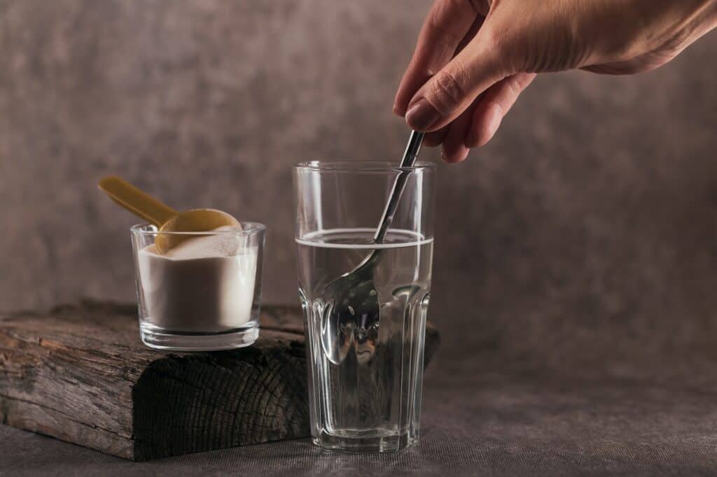 Glass with collagen dissolved in water and collagen protein powder