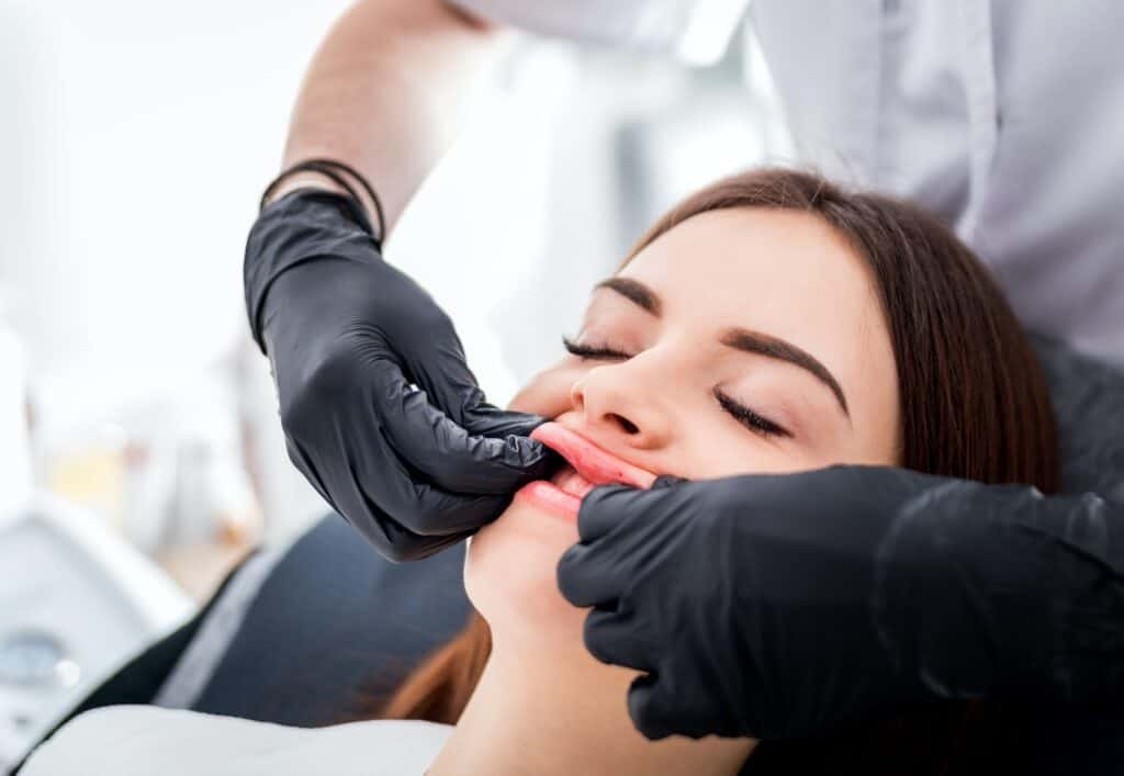 Massage after enlarging lips at beauty salon