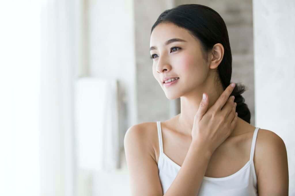 Young woman rubbing neck