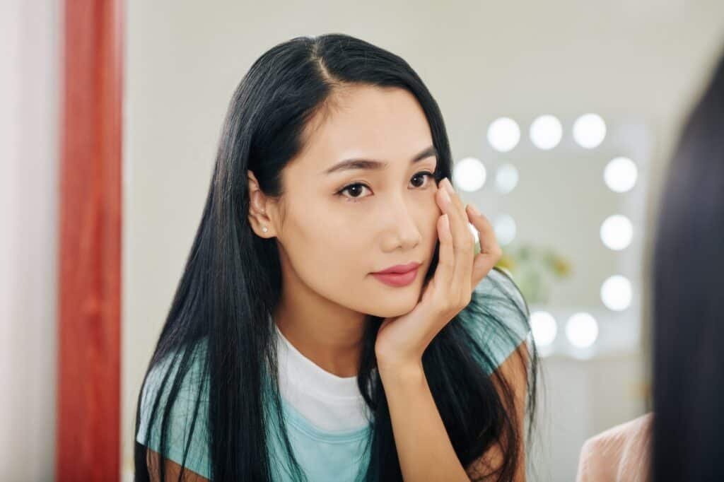 Woman applying under eye cream