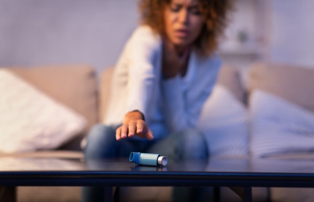 Asmathic girl catching inhaler having asthma attack