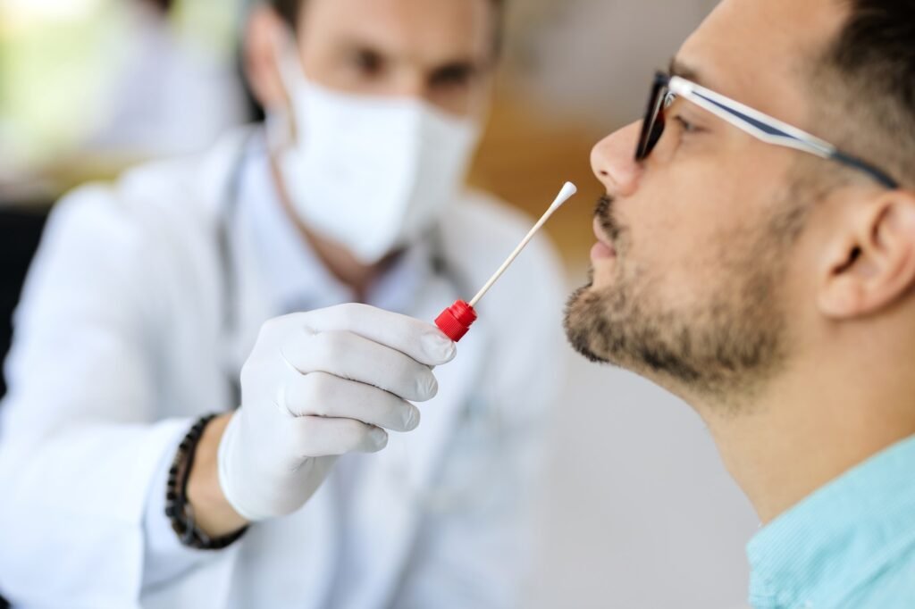Close-up of a man having PCR test at medical clinic.
