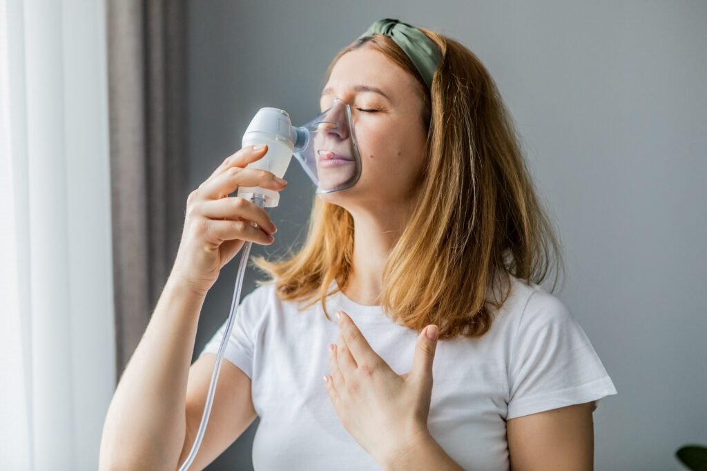 middle-aged woman makes inhalation at home. Cold respiratory diseases. Influenza and viral infection