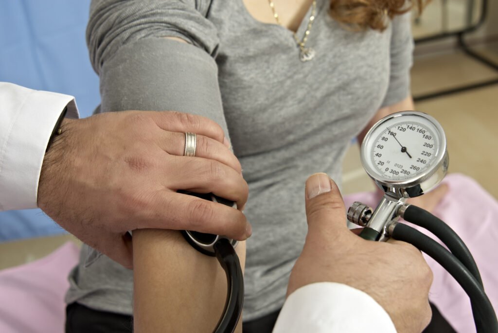 Closeup shot of a doctor checking the blood pressure of a patient